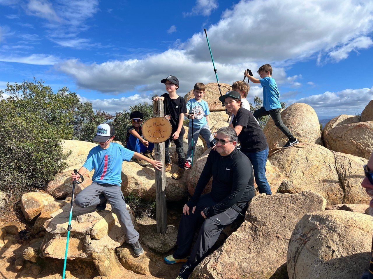 Boys and a dad beside the Iron Mountain summit sign